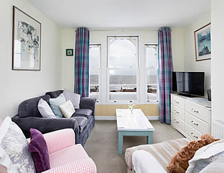 Spacious and comfortably furnished sitting room with double bed and superb, panoramic sea views
